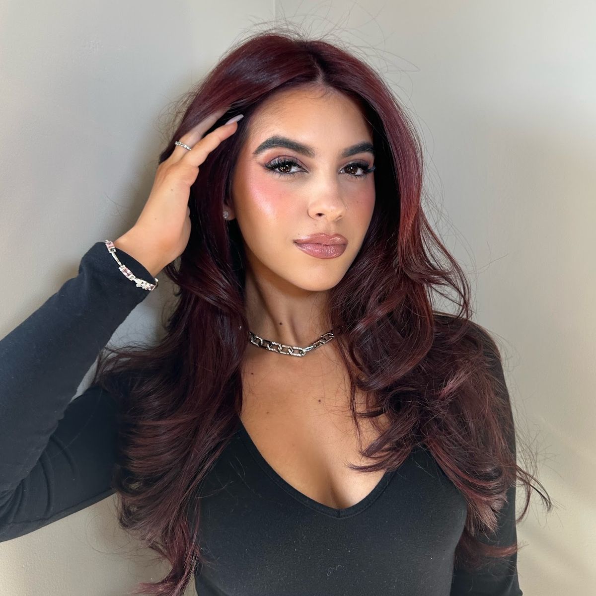 Long, glossy light-brown hair color with soft waves