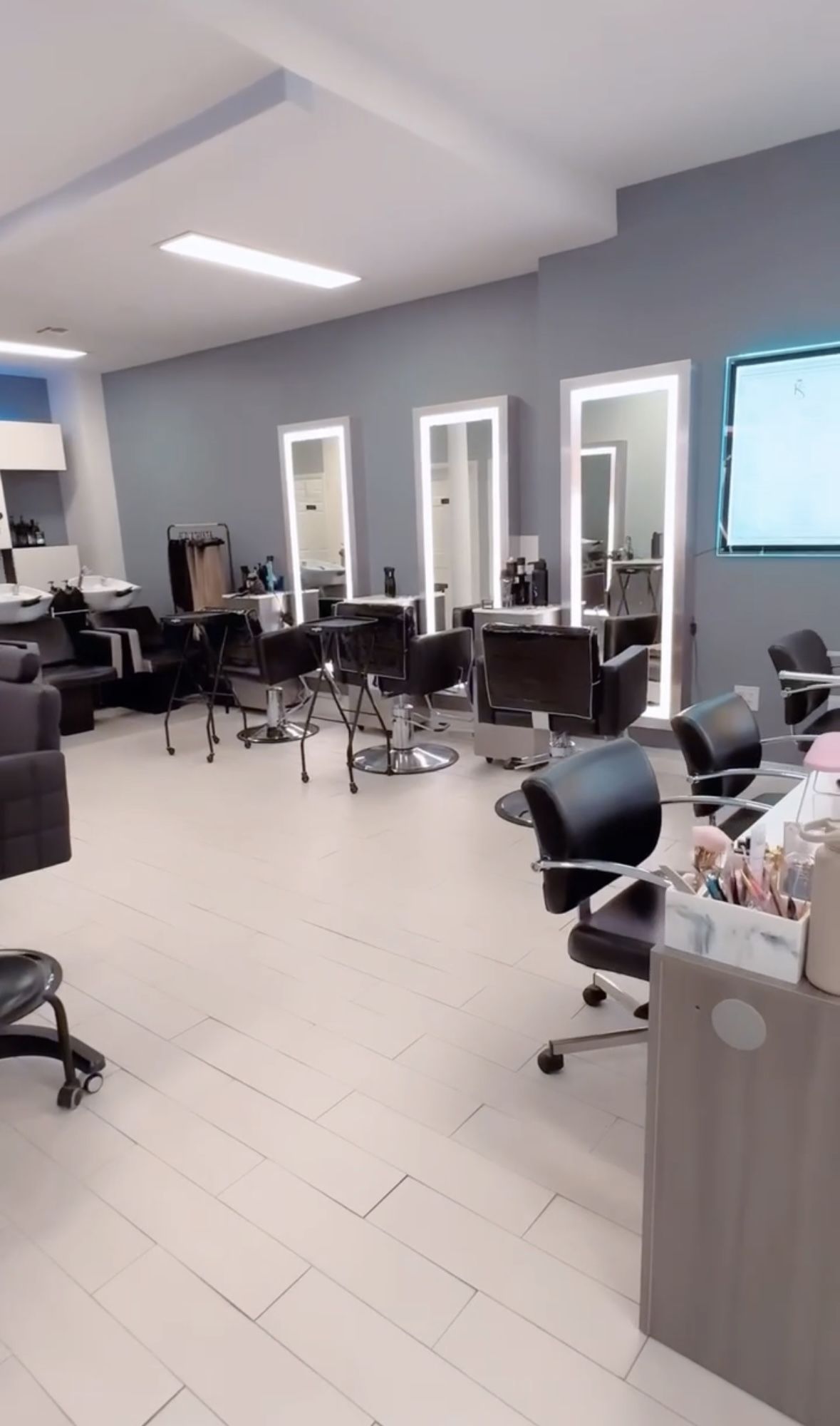The bright salon floor at KS Beauty Center with styling chairs and mirrors